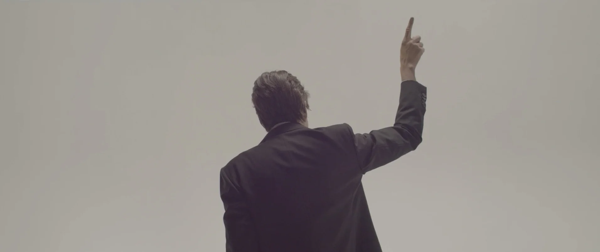 Reference frame: the character raises an arm with their back to the camera.