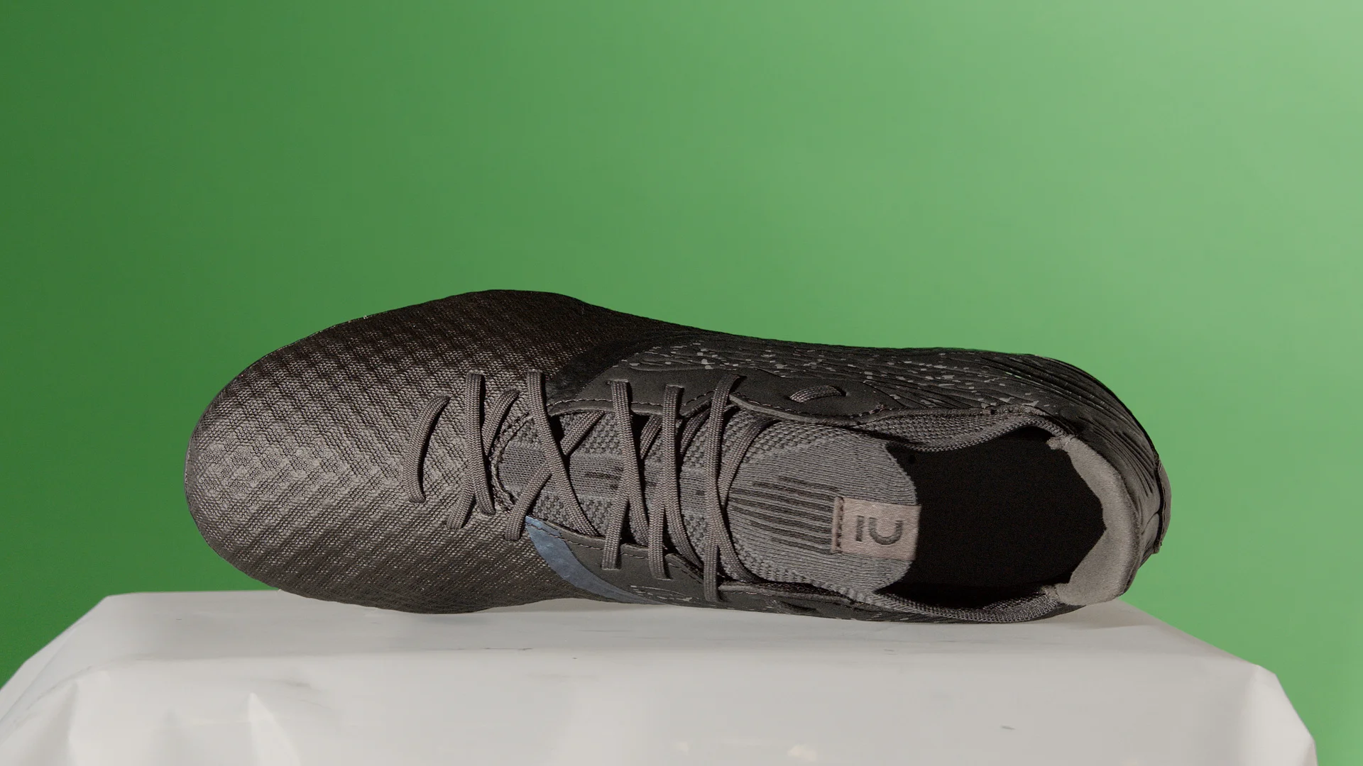 Before — The same frame of the FG boot: green background and shooting support, then the isolated product on transparency.