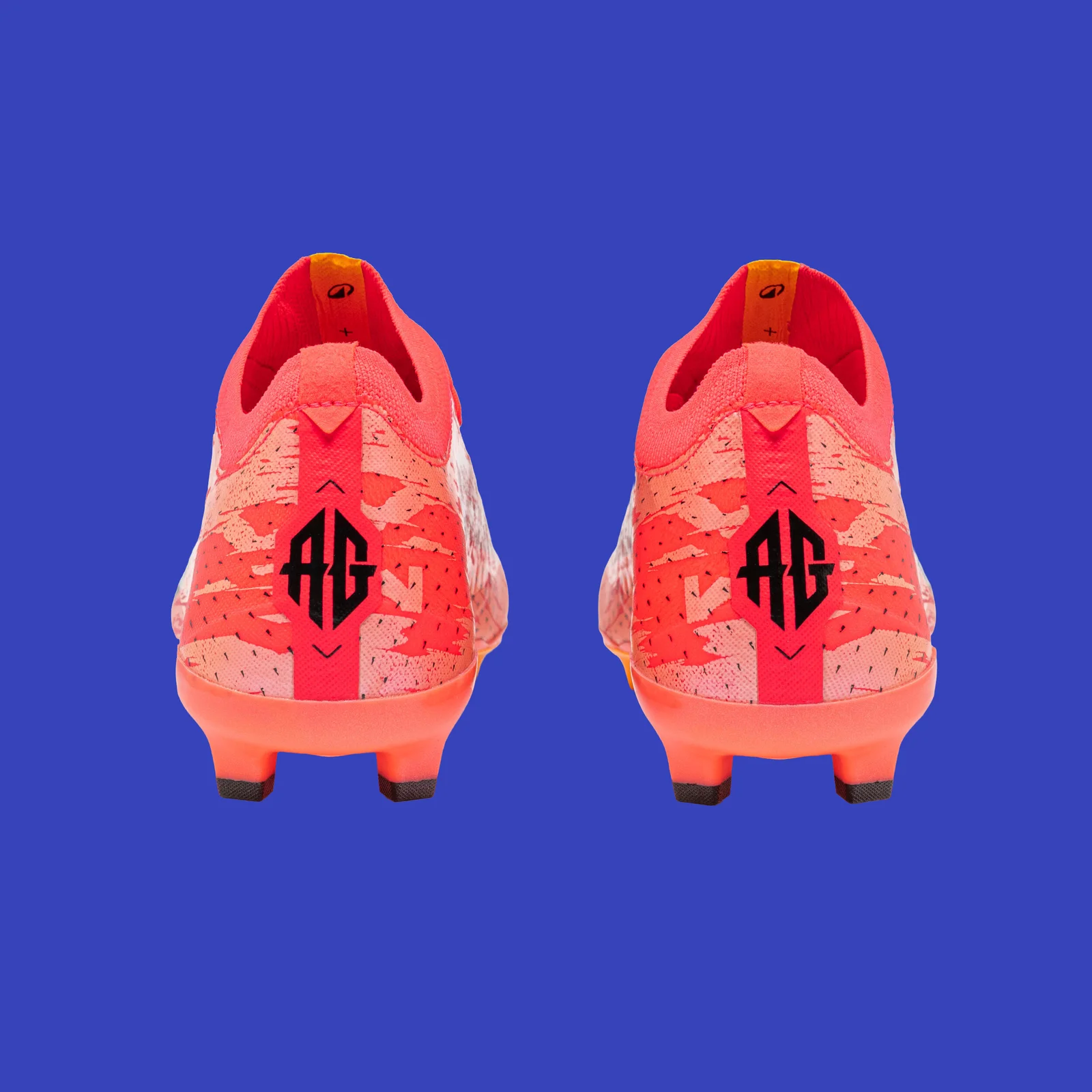 Rear view of the pink Kipsta CLR Red Storm boots with black heel monograms.
