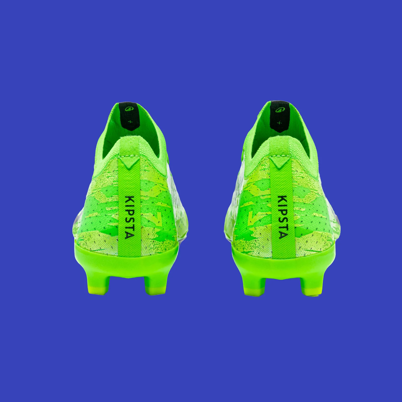 Rear view of the green Kipsta CLR Green Storm boots on a blue background.