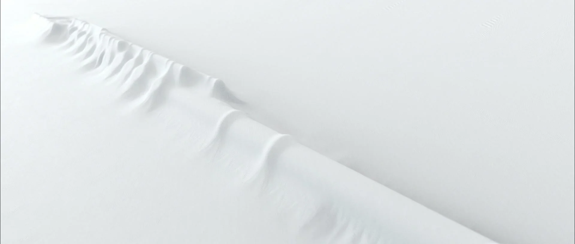 Undulating white relief crossed by a diagonal ridge.