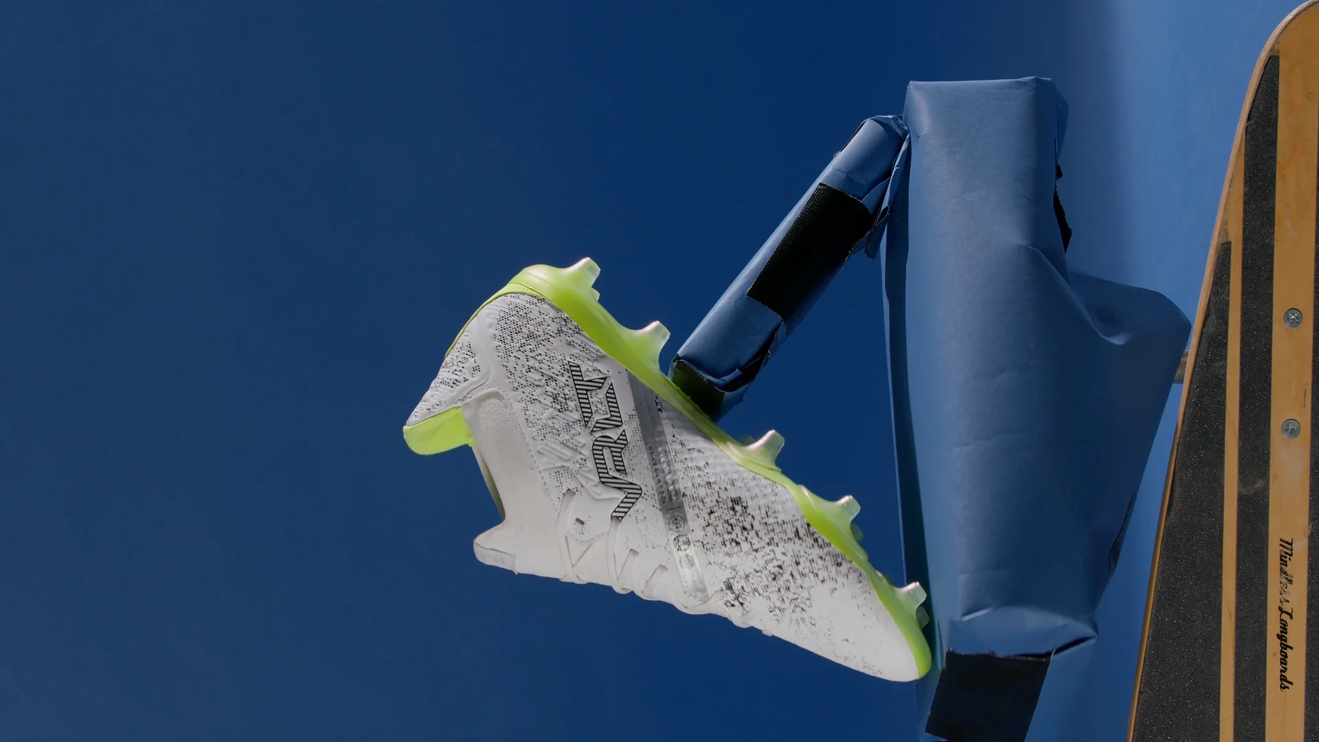 Before — The same frame of the green boot: blue screen and support visible on set, then the isolated product.